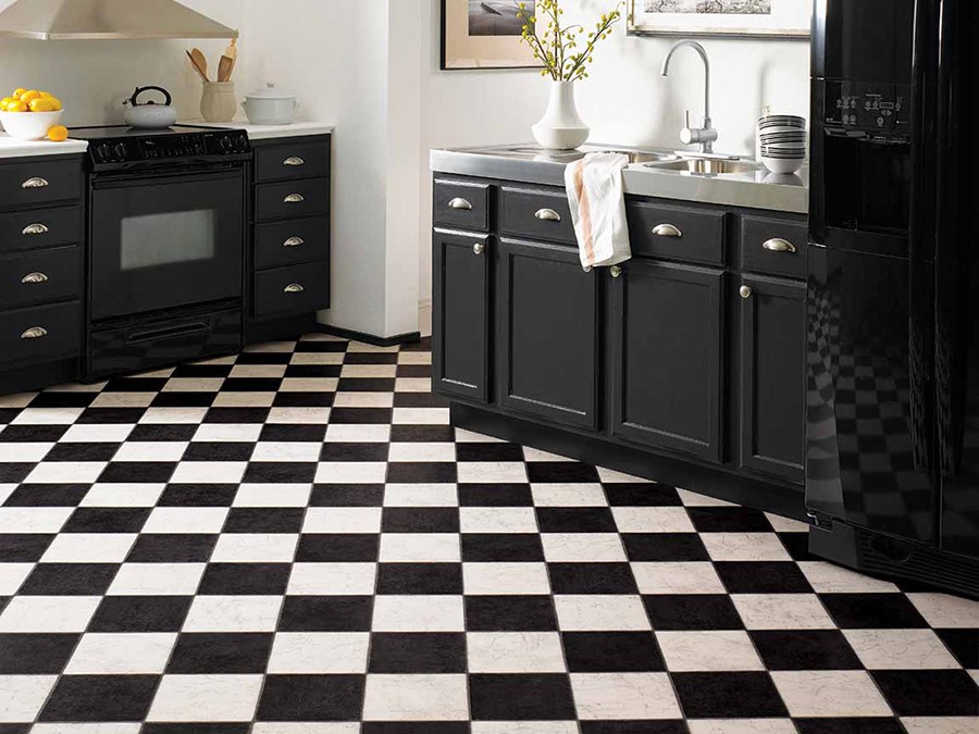 Black and white checkered mosaic tile floor in kitchen